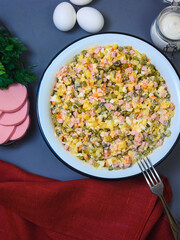 Russian New Year salad Olivier in a large enamel bowl - flatlay