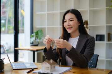 Business woman or Agent giving house key after signing agreement for buying house. Bank manager and real estate concept.