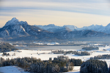 panoramic view to alps mountain range and lake Forggensee in Bavaria at winter