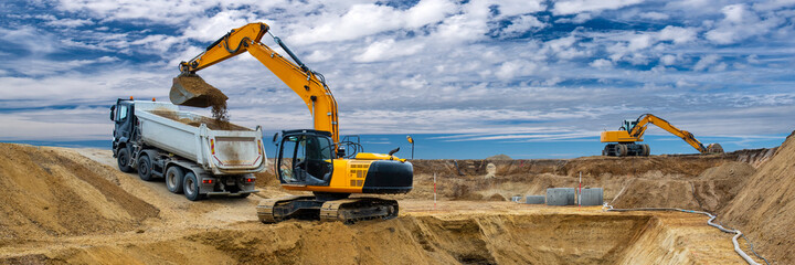 digger and excavator at work in construction site - obrazy, fototapety, plakaty