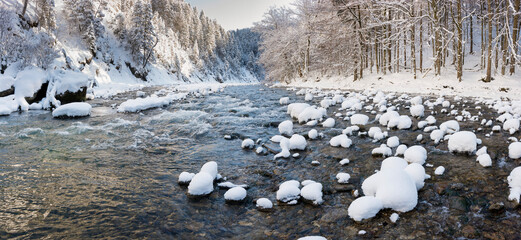 river Ammer in Bavaria at cold winter day with snow