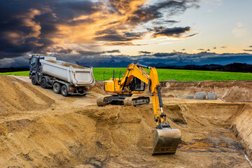 digger and excavator at work in construction site