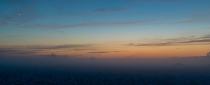 winter sunset in fog, panorama photo