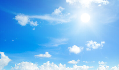 Naklejka na ściany i meble Blue sky, sun and clouds. Wide photo.