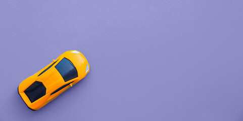 Yellow car against the backdrop of the trendy 2022 color of the year Very Peri. Color of the year 2022. Background for designers, automotive concept. Copy space. Long banner	