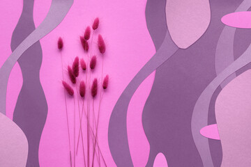 Monochrome pink and magenta abstract paper background with dry bunny tail grass and natural organic...