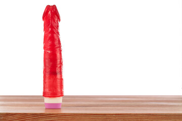 Vibrator sex toy for adults. Red dildo in foreground Space for text, copy space. Flat - obrazy, fototapety, plakaty