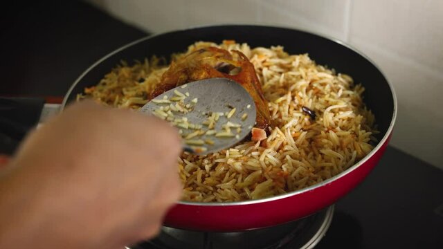 Arabic chicken Manthi mandi cooked meat Basmati rice with Masala spice woman hand serving cooking Kuzhimanthi hot spicy Manthi 4K video footage Malabar Kerala South India Indian non veg food Sri Lanka