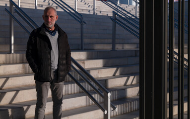 Adult man in winter cloth on stairway. Madrid, Spain