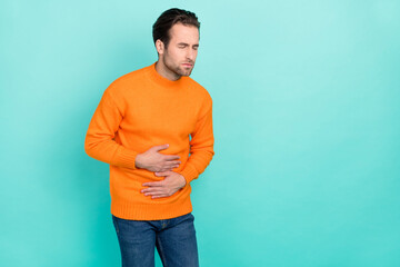 Portrait of unsatisfied person arm on stomach closed eyes feel bad isolated on teal color background