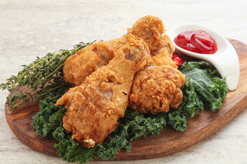 Fried chicken drumsticks with tomato sauce