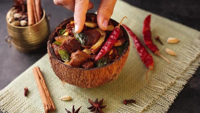 Traditional homemade Mutton curry from Asian cuisine Chukhandar gosht woman hand eating spicy meat beef curry coconut 4K video footage mutton roast Indian spices. side dish Ghee rice Appam Parotta 
