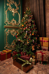 beautiful decorated Christmas tree with golden balls and toys and many boxes of different sizes with gifts under it