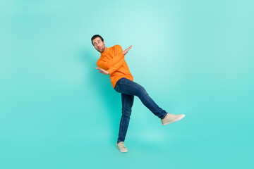 Full size photo of young man have fun chill clubber look empty space isolated over teal color...