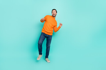 Fototapeta na wymiar Full length photo of cheerful satisfied man have fun dancing partying weekend isolated on turquoise color background