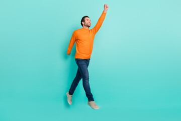 Full length profile portrait of cheerful man raise arm empty space hold imagine umbrella isolated on teal color background