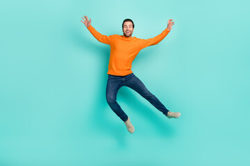 Fototapeta na wymiar Full length photo of cheerful overjoyed person flying have fun isolated on turquoise color background