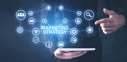 Human holding tablet with a Marketing Strategy concept.