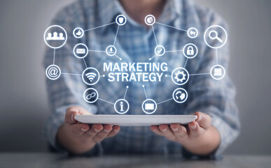 Human holding tablet with a Marketing Strategy concept.