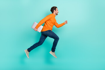 Full body profile side photo of young guy run rush fast hold laptop jumper isolated over teal color...