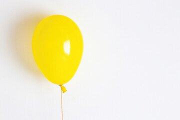 Yellow balloon. Yellow festive, joyful balloon on a string. 