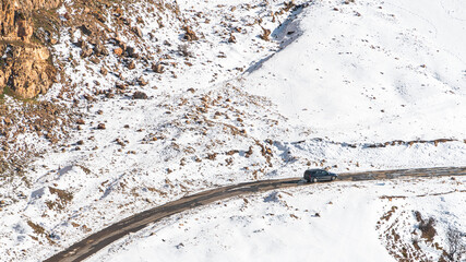 Car on winter road in mountain area