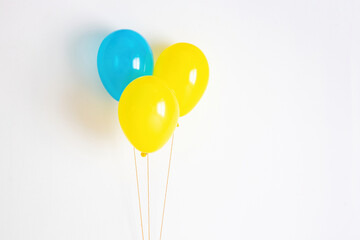 Yellow with blue balloon. Yellow and blue festive, joyful balloon on a string. 