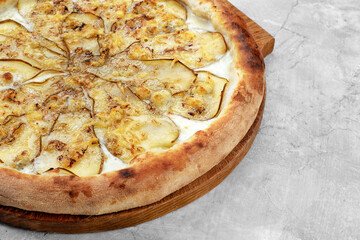 Pizza with pear, gorgonzola and on stone background. Top view.