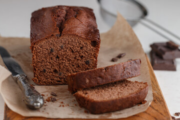 Homemade freshly baked chocolate pound cake loaf. Delicious homemade dessert. Slices on a cutting board. Selective focus - 475144793