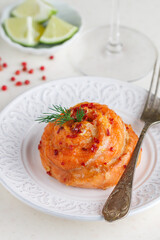 Baked salmon fillet roll with pink pepper, dill and lime. Seafood. Mediterranean cuisine. A treat for the party. Delicious gourmet dinner. Selective focus