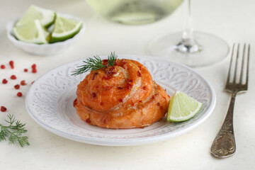 Baked salmon fillet roll with pink pepper, dill and lime. Seafood. Mediterranean cuisine. A treat for the party. Delicious gourmet dinner. Selective focus