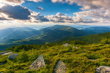 outdoor adventure scenery in mountains. beautiful green summer landscape. stones on the grassy hill...