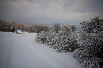 drive way to country house in winter time, snow covered everything