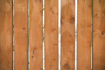 Wooden plank light-brown fence close-up, pattern, background