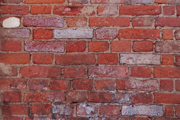 Old shabby red brick wall, worn background