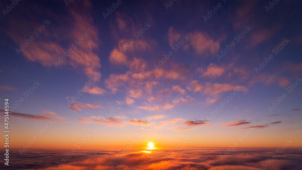 Sticker Beautiful photo of view on setting sun above the clouds. Aerial drone photo of heaven-like sky