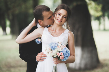 Sensual portrait of a young wedding couple. Outdoor