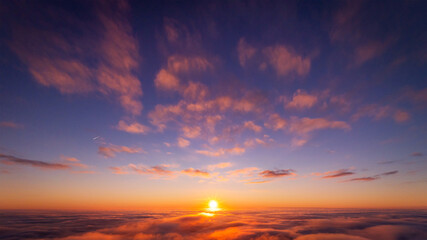 Fototapeta na wymiar Beautiful photo of view on setting sun above the clouds. Aerial drone photo of heaven-like sky