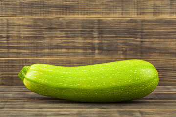 Zucchini on wooden background.