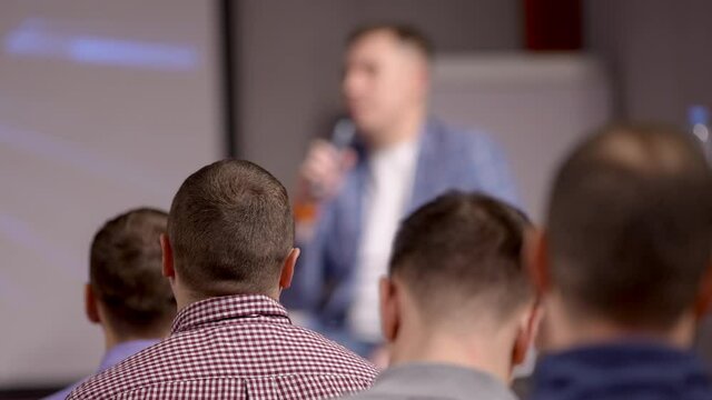 Business trainer giving presentation to group of audience people. Male Speaker man seminar public on stage speaking conference, Meeting, Businessman colleagues training corporate coaching concept
