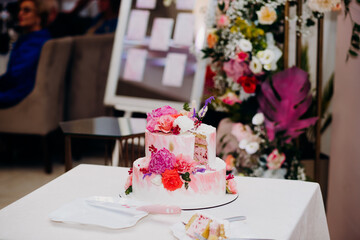 Wedding cake bride and groom with pink peonies