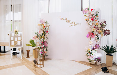 Decoration of the wedding hall with flowers in pink and white shades