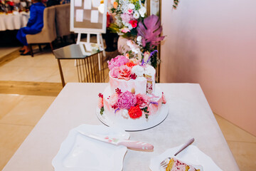 Wedding cake bride and groom with pink peonies