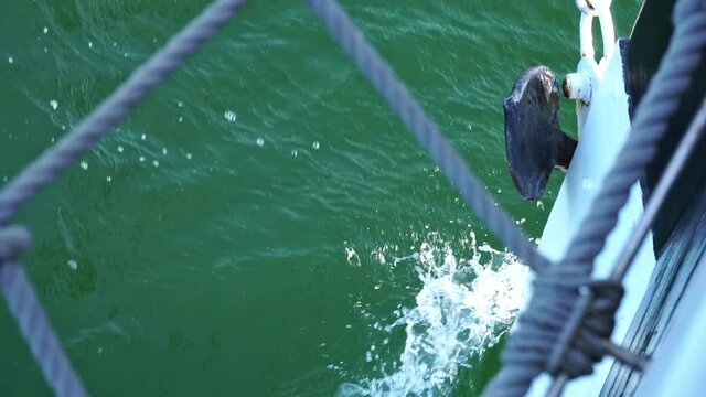 Old Sailing Ship with Bow Wave and Anchor in Summer - Front View through Bowsprit Net with different Focus
