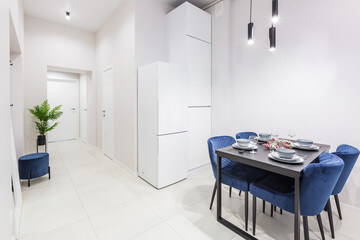 Interior of a small bright kitchen in a small modern apartment with white walls