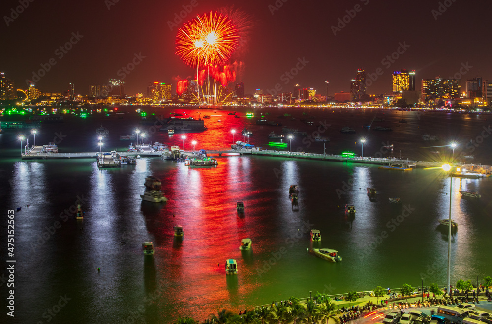 Sticker colorful fireworks display over the night sky of the city during a festival