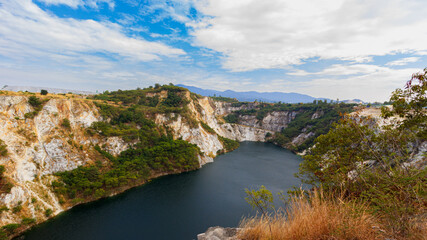Fototapeta na wymiar Grand Canyon, a quarry that looks like a rocky mountain with a river in the middle, in Chonburi Province, Thailand.