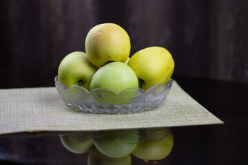 Fresh autumn yellow apples on a plate