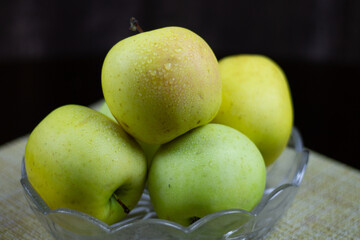Fresh autumn yellow apples on a plate