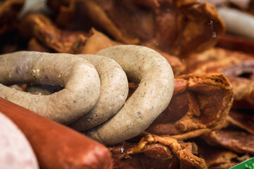 Shallow depth of field (selective focus) image with traditional Romanian winter holidays meat foods for sale in an outdoors market in Bucharest, Romania.